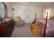 Spacious bedroom featuring a dresser, accent chair, and a luxurious four poster bed at 223 Valdiva St, Punta Gorda, FL 33983