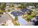 This aerial view showcases a home with an enclosed pool, solar panels, and a well-maintained landscaped yard at 23144 Donalda Ave, Port Charlotte, FL 33954