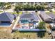 Home's aerial view shows the pool, playground, custom pergola, and fenced yard at 23144 Donalda Ave, Port Charlotte, FL 33954