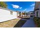 Spacious backyard featuring a pergola, outdoor seating, and a screened-in pool enclosure providing ample space at 23144 Donalda Ave, Port Charlotte, FL 33954