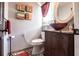 Bathroom features vessel sink on dark cabinet and unique pebble flooring at 23144 Donalda Ave, Port Charlotte, FL 33954