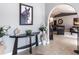 Warm foyer view with decorative table, tiled floor, and an archway leading to the living spaces at 23144 Donalda Ave, Port Charlotte, FL 33954