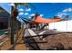 Backyard playground featuring a shade sail, sandbox, and play structure at 23144 Donalda Ave, Port Charlotte, FL 33954