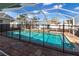 Sparkling screened-in pool area with a safety fence and covered seating offering a perfect outdoor retreat at 23144 Donalda Ave, Port Charlotte, FL 33954