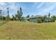 Expansive back yard offering plenty of space for outdoor activities and potential landscaping opportunities at 23411 Superior Ave, Port Charlotte, FL 33954