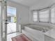 Bright bathroom featuring garden tub, natural light, and access to the outdoors at 23411 Superior Ave, Port Charlotte, FL 33954