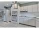 Well-lit kitchen with white cabinets, appliances, and a tiled floor at 23411 Superior Ave, Port Charlotte, FL 33954