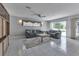 Cozy living room featuring tile flooring, ceiling fan, and comfortable seating at 23411 Superior Ave, Port Charlotte, FL 33954