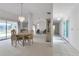 Bright living room and dining area featuring chandelier, neutral colors, and sliding door access at 23411 Superior Ave, Port Charlotte, FL 33954