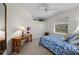 Cozy bedroom featuring a ceiling fan, nautical-themed bedding, and bright natural light at 237 Freeport Ct, Punta Gorda, FL 33950