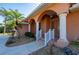 Mediterranean-style home featuring an arched entryway, decorative columns, and a well-manicured lawn at 237 Freeport Ct, Punta Gorda, FL 33950