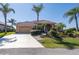 Lovely single-story home featuring a red tiled roof, a two-car garage, and tropical landscaping at 237 Freeport Ct, Punta Gorda, FL 33950