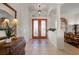 Bright foyer featuring double doors with decorative glass, tile flooring, and classic columns at 237 Freeport Ct, Punta Gorda, FL 33950