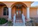 Elegant front entrance featuring double doors, decorative pillars, and manicured landscaping at 237 Freeport Ct, Punta Gorda, FL 33950