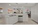 Well-lit kitchen featuring a stainless steel dishwasher and white cabinetry at 237 Freeport Ct, Punta Gorda, FL 33950