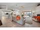 Open-concept living room showcasing access to the lanai, with the kitchen in the background at 237 Freeport Ct, Punta Gorda, FL 33950