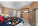 Well-lit main bedroom featuring a ceiling fan and built-in shelves for storage at 237 Freeport Ct, Punta Gorda, FL 33950