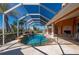 Enjoy the outdoors in this screened-in private pool with lush landscaping and views of the waterfront community at 237 Freeport Ct, Punta Gorda, FL 33950