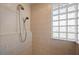 Elegant tile shower with glass block window and dual shower heads in renovated bathroom at 237 Freeport Ct, Punta Gorda, FL 33950