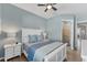 Calm bedroom featuring a white bed and blue accents, with an en-suite bathroom at 25197 Keygrass Ct, Punta Gorda, FL 33955