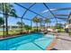 Beautiful screened pool with outdoor seating area, spa, and lush landscaping provides a relaxing backyard oasis at 25197 Keygrass Ct, Punta Gorda, FL 33955