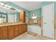 Bathroom featuring double vanity, a soaking tub, and decorative tile work at 27566 Tierra Del Fuego Cir, Punta Gorda, FL 33983