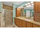 Bathroom with a large mirror, walk-in shower, and double sink vanity at 27566 Tierra Del Fuego Cir, Punta Gorda, FL 33983