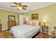 Comfortable bedroom featuring hardwood floors, a ceiling fan, and neutral wall color at 27566 Tierra Del Fuego Cir, Punta Gorda, FL 33983