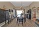 Bright dining room features wood flooring, a modern chandelier, and a view of the pool at 27566 Tierra Del Fuego Cir, Punta Gorda, FL 33983