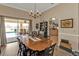 A cozy dining area features wood floors, a modern chandelier, and a view of the pool at 27566 Tierra Del Fuego Cir, Punta Gorda, FL 33983