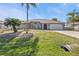 Beautiful single-story home features a two-car garage, arched windows, mature landscaping and a well maintained lawn at 27566 Tierra Del Fuego Cir, Punta Gorda, FL 33983