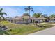 Charming single-story home with a well-manicured lawn and mature palm trees in a desirable neighborhood at 27566 Tierra Del Fuego Cir, Punta Gorda, FL 33983