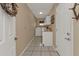 This cozy laundry room features white cabinets, a sink, washer, and dryer at 27566 Tierra Del Fuego Cir, Punta Gorda, FL 33983