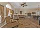 A cozy living room with neutral paint, multiple seating options and a view into the dining area at 27566 Tierra Del Fuego Cir, Punta Gorda, FL 33983