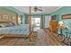 Spacious main bedroom with aqua walls and backyard pool access at 27566 Tierra Del Fuego Cir, Punta Gorda, FL 33983