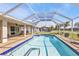 Beautiful screened-in pool with a large patio and lush backyard at 27566 Tierra Del Fuego Cir, Punta Gorda, FL 33983