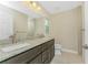 Bathroom featuring double sinks, granite countertop, and tile flooring at 2851 Verde Ter, North Port, FL 34286