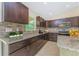 Close up on kitchen with granite counters, wood cabinets, stainless steel appliances, and decorative backsplash at 2851 Verde Ter, North Port, FL 34286