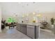 Open-concept kitchen island with stainless steel appliances, granite countertops, and pendant lighting at 2851 Verde Ter, North Port, FL 34286