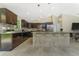 Kitchen featuring granite countertops, custom backsplash, and dark wood cabinets. with stainless appliances at 2851 Verde Ter, North Port, FL 34286