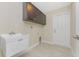 Bright laundry room with modern cabinets, wash basin, and neutral tile flooring at 2851 Verde Ter, North Port, FL 34286