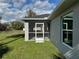 Exterior view of the screened-in porch with well-maintained yard at 2851 Verde Ter, North Port, FL 34286