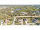 Beautiful aerial view of a residential neighborhood surrounded by lush nature and a winding river at 295 Porto Alegre St, Punta Gorda, FL 33983