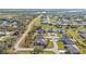 Aerial view of a residential community featuring landscaped yards and sidewalks near a winding river at 295 Porto Alegre St, Punta Gorda, FL 33983