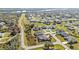 An expansive aerial view of houses in a scenic planned community with sidewalks, yards, and green spaces at 295 Porto Alegre St, Punta Gorda, FL 33983