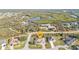 An aerial view of the house, showing the surrounding landscape, including a river and trees at 295 Porto Alegre St, Punta Gorda, FL 33983