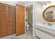 Bathroom featuring white vanity, decorative mirror, and a door to the toilet at 295 Porto Alegre St, Punta Gorda, FL 33983