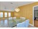 Open dining area with tile flooring, a modern chandelier, and natural lighting at 295 Porto Alegre St, Punta Gorda, FL 33983