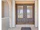 Elegant double front doors with decorative glass inserts and sidelights, providing a grand entrance at 295 Porto Alegre St, Punta Gorda, FL 33983