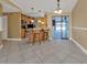 Open concept kitchen with breakfast bar featuring tile floors, stainless appliances, and light wood cabinets at 295 Porto Alegre St, Punta Gorda, FL 33983